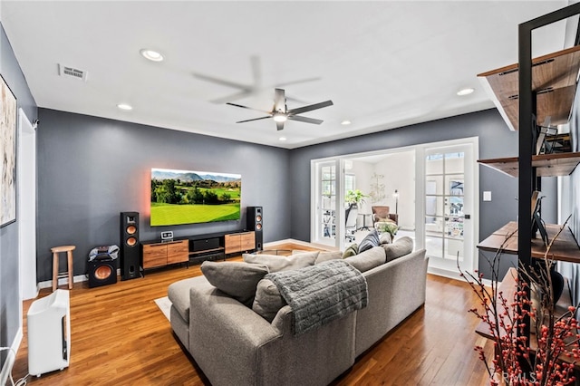 living room featuring hardwood / wood-style floors, french doors, and ceiling fan