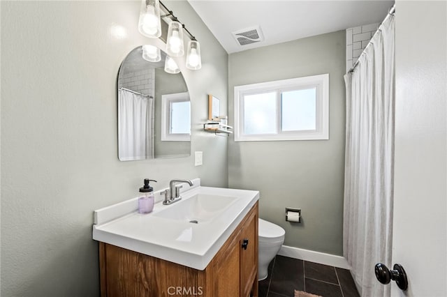 bathroom with vanity, tile patterned flooring, and toilet