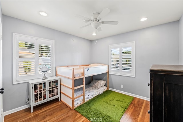 bedroom with hardwood / wood-style floors and ceiling fan