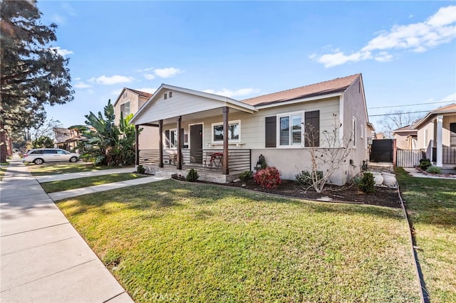 view of front of home with a front yard and a porch