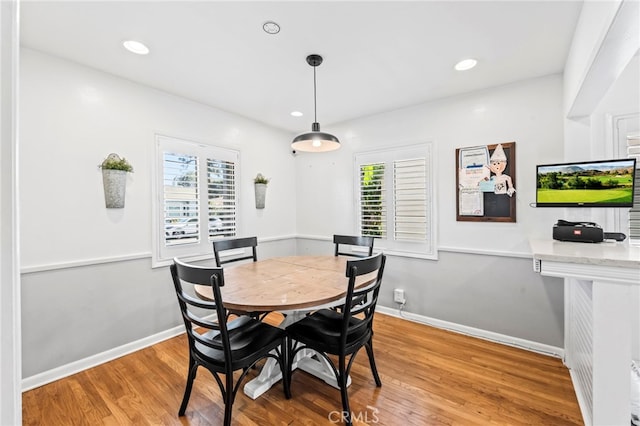 dining space featuring wood-type flooring and a wealth of natural light