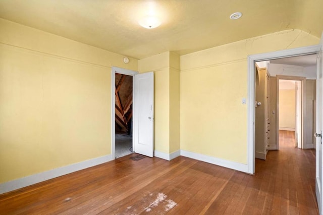 spare room with wood-type flooring