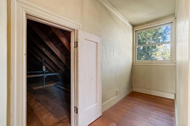 corridor featuring wood-type flooring and vaulted ceiling