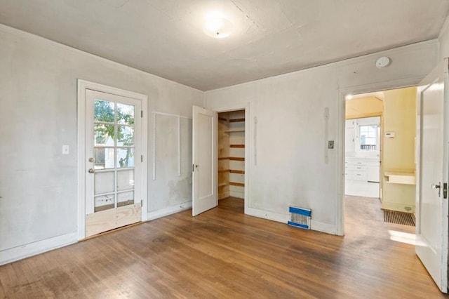 interior space with a healthy amount of sunlight and hardwood / wood-style floors