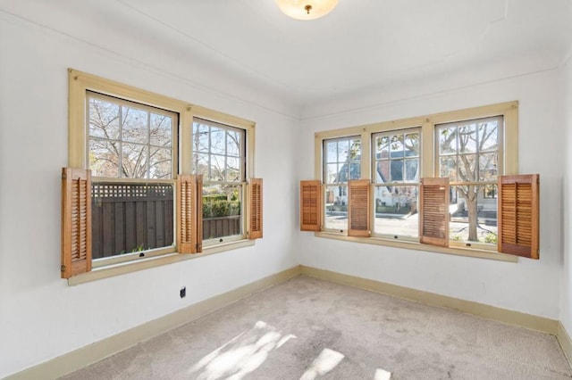 carpeted empty room with a healthy amount of sunlight