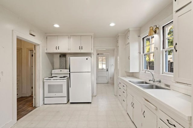 kitchen featuring sink, white cabinets, white appliances, and decorative backsplash