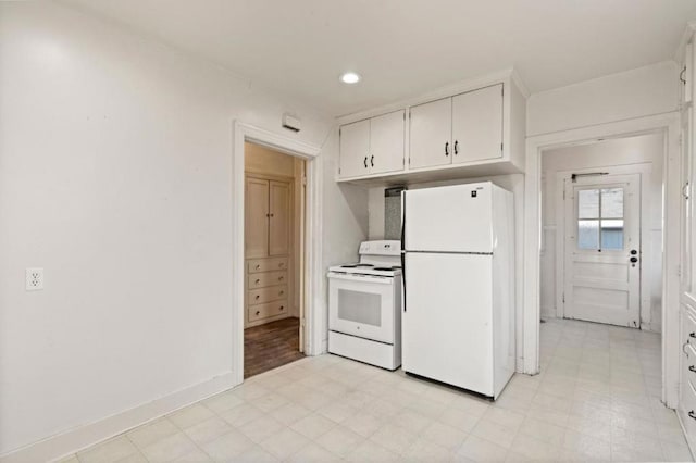 kitchen with white appliances and white cabinets