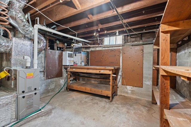 basement featuring heating unit and a workshop area