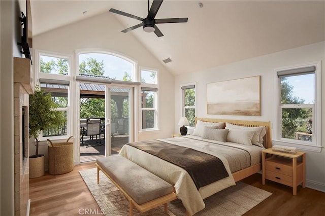 bedroom with access to exterior, high vaulted ceiling, hardwood / wood-style floors, and ceiling fan