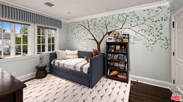 bedroom featuring ornamental molding and wood-type flooring