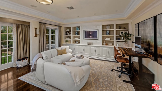 office area featuring a healthy amount of sunlight, dark hardwood / wood-style floors, and built in shelves