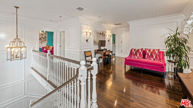 hallway with a notable chandelier, ornamental molding, and dark hardwood / wood-style floors