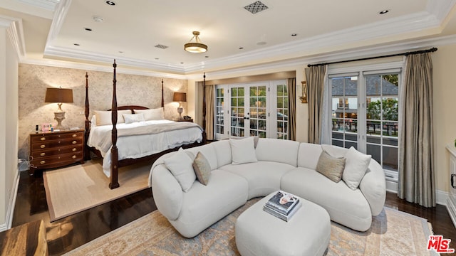 bedroom with french doors, a raised ceiling, hardwood / wood-style floors, and multiple windows