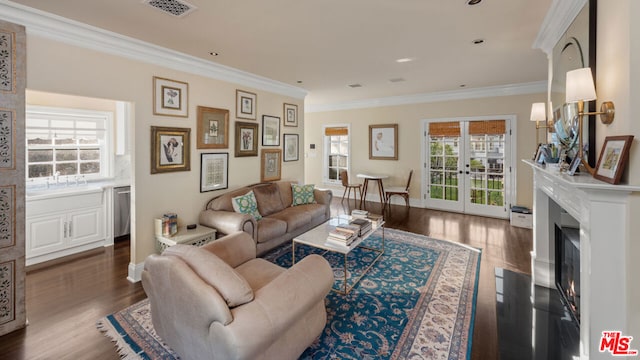 living room with crown molding, dark hardwood / wood-style flooring, and french doors