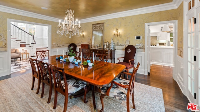 dining room featuring a notable chandelier, ornamental molding, and dark hardwood / wood-style floors