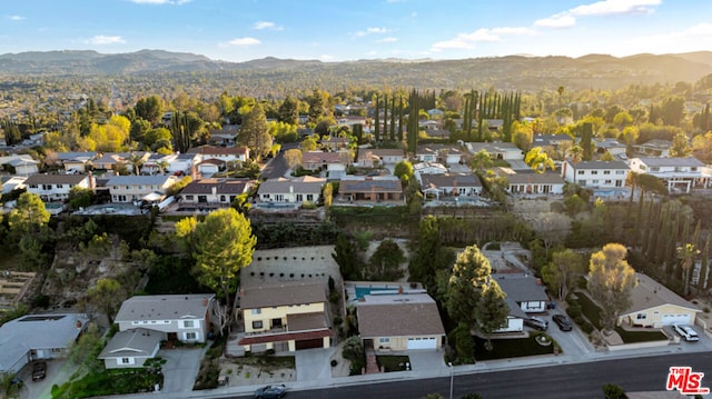 birds eye view of property with a mountain view