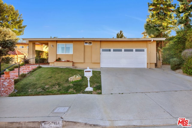 ranch-style home featuring a garage and a front yard