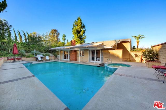 view of pool featuring an in ground hot tub, area for grilling, and a patio