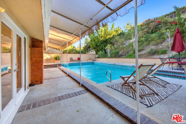 view of pool featuring a patio