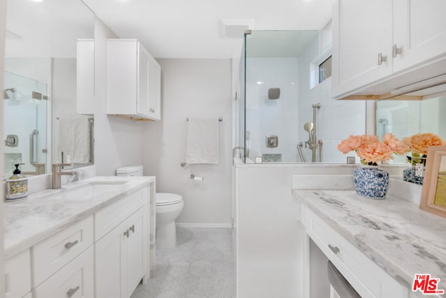 bathroom featuring vanity, toilet, and walk in shower