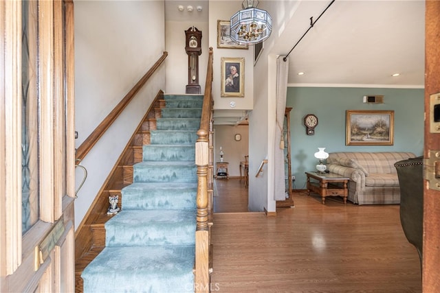 stairway featuring hardwood / wood-style flooring and ornamental molding