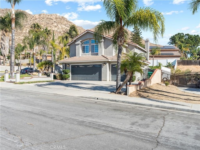 view of front of property with a garage and a mountain view