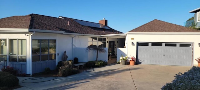 rear view of property featuring a garage