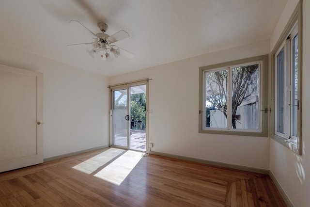 empty room featuring ceiling fan and light hardwood / wood-style flooring