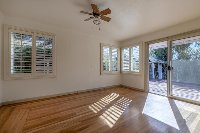 spare room with ceiling fan and light wood-type flooring