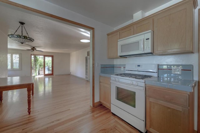 kitchen featuring hanging light fixtures, tile counters, ceiling fan, light brown cabinets, and white appliances