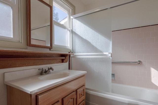 bathroom with vanity and tiled shower / bath combo