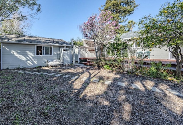 rear view of property featuring a wooden deck