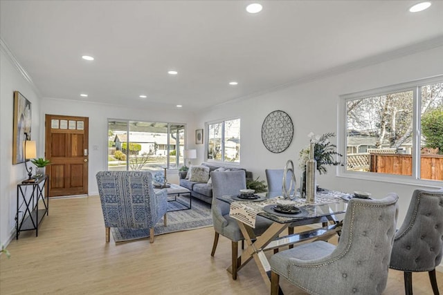 dining room featuring ornamental molding and light wood-type flooring