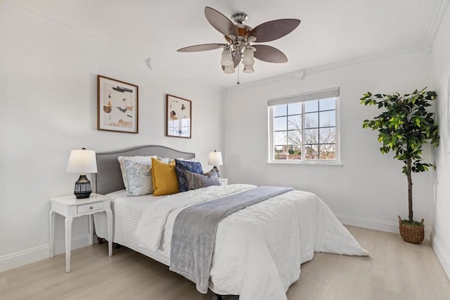 bedroom featuring ornamental molding, ceiling fan, and light hardwood / wood-style floors