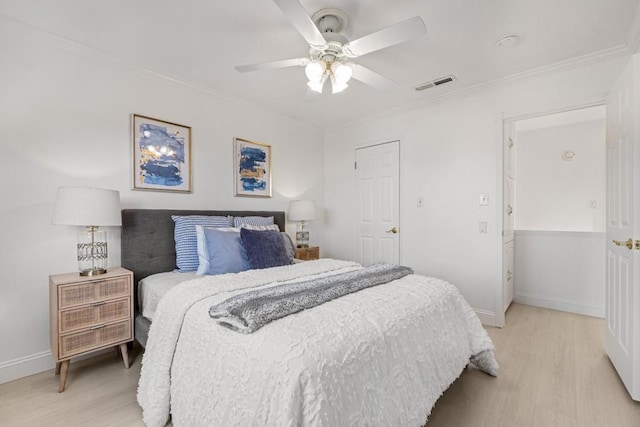 bedroom with ceiling fan, ornamental molding, and light wood-type flooring