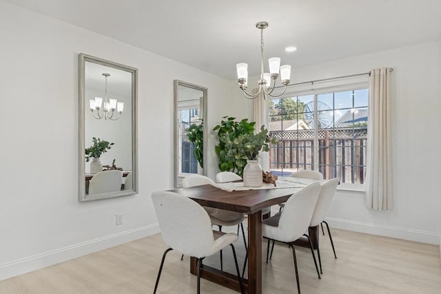 dining room with a chandelier and light hardwood / wood-style flooring