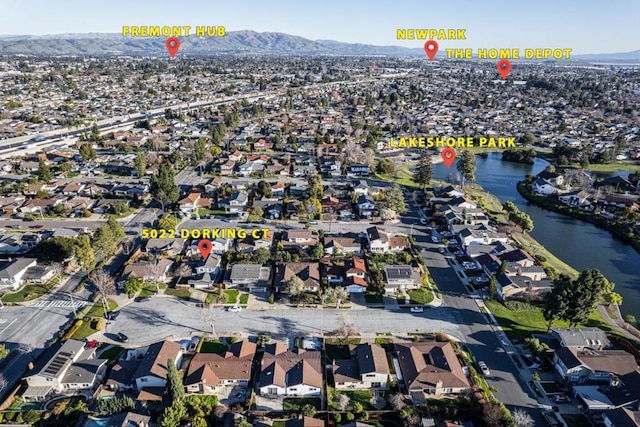 drone / aerial view featuring a water and mountain view