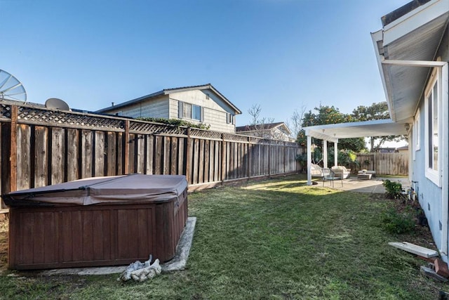 view of yard featuring a hot tub and a patio