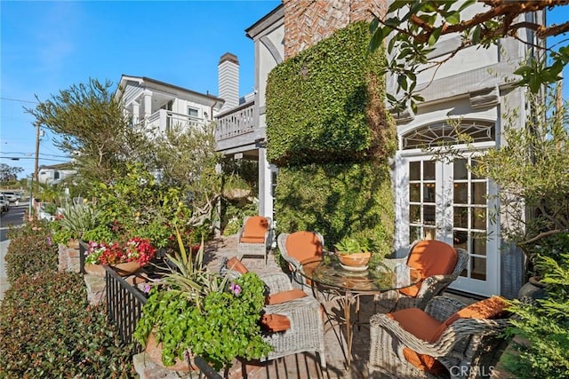 view of patio featuring french doors and a balcony