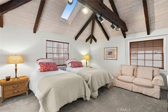 carpeted bedroom with wood ceiling, vaulted ceiling with skylight, and rail lighting