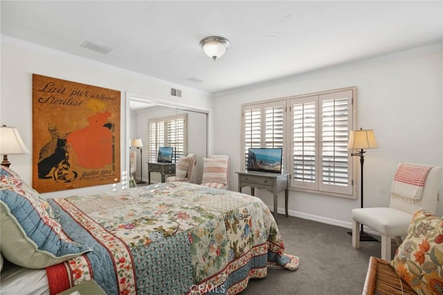 bedroom featuring a closet, ornamental molding, and carpet