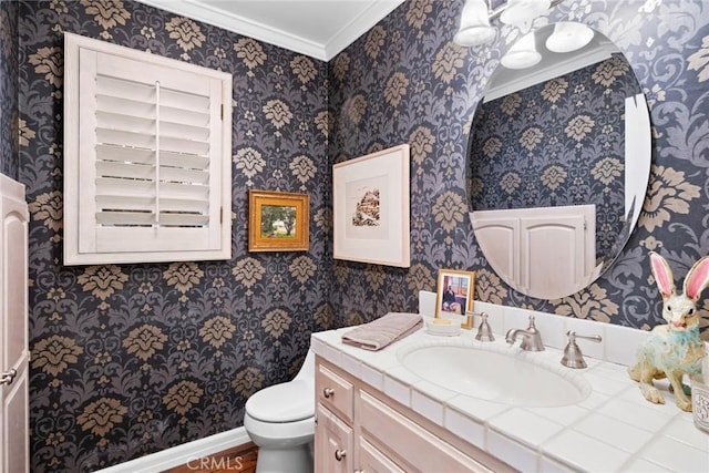 bathroom featuring vanity, crown molding, and toilet