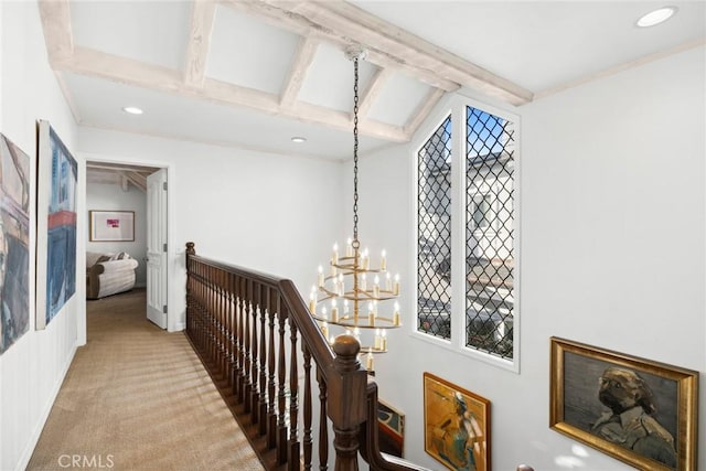 corridor with carpet flooring, an inviting chandelier, and beam ceiling