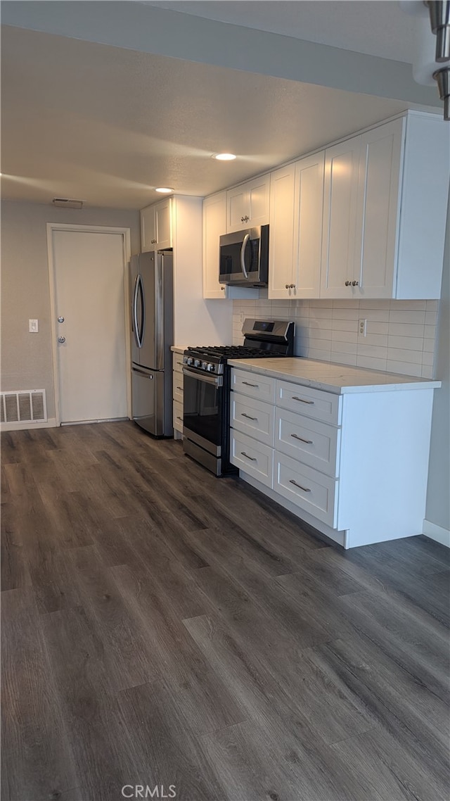 kitchen featuring white cabinetry, dark hardwood / wood-style flooring, and stainless steel appliances