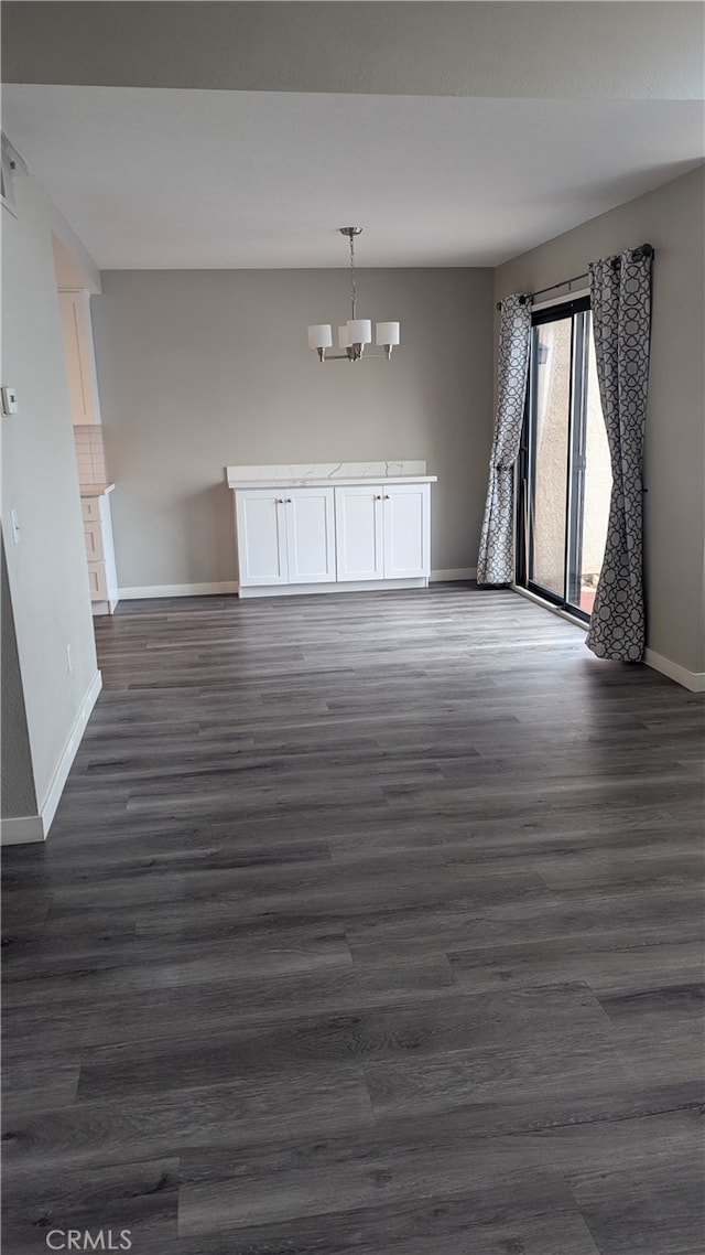 interior space with dark hardwood / wood-style floors and a chandelier