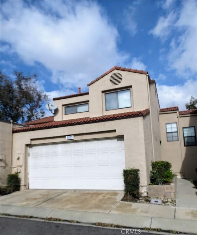 mediterranean / spanish-style house featuring a garage