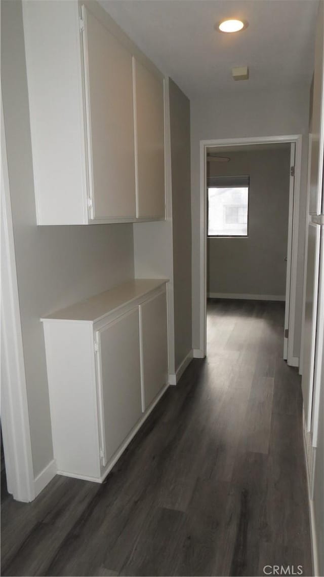 hallway featuring dark hardwood / wood-style flooring