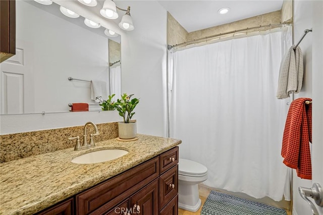full bathroom with tile patterned flooring, toilet, vanity, and curtained shower