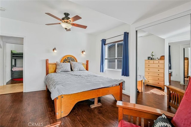 bedroom featuring ceiling fan, baseboards, and wood-type flooring