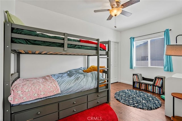 bedroom featuring wood finished floors and ceiling fan